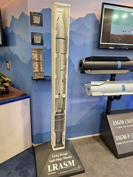 A 1/4 scale model of a canistered LRASM-SL configuration for use with Mk 41 Strike Length VLS. Note the booster. To the immediate left of the LRASM-SL is a smaller-scale model of Mk 41 VLS configured with four LRASM-SL effectors.
