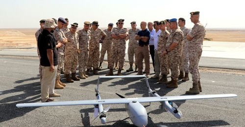 Major General Yousef Ahmed al-Hunaiti inspects the UAV that was used to carry supplies.