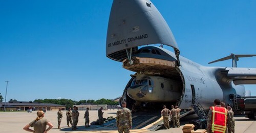 A Boeing CH-47F Chinook is removed from the cargo area of a Lockheed C-5M Galaxy at the Seymour Johnson Air Force Base in North Carolina on 18 June 2021. The USAF used C-17As and C-130s for its evacuation of Kabul instead of the C-5M, despite the Super...