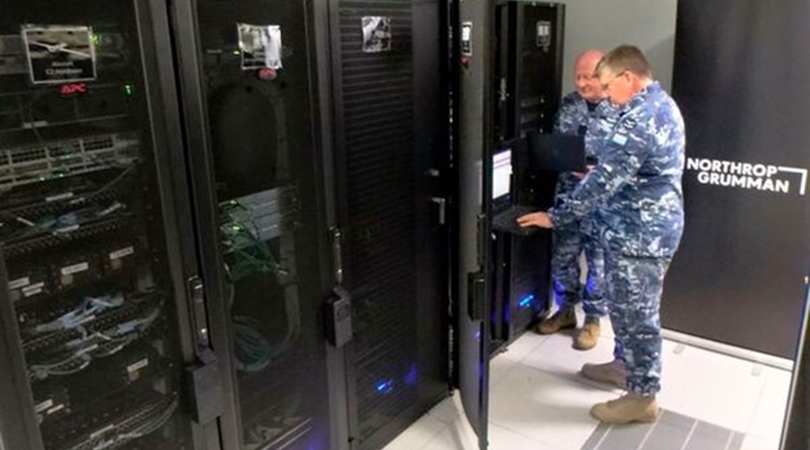 Flight Lieutenants Douglas Hogg and Davis Strauss from the ISR Transition Office at RAAF Base Edinburgh reviewing the Triton network configuration files on the newly delivered NITE.