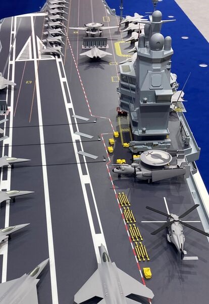 A helicopter operating spot has been introduced on the starboard quarter. In addition, a maintenance area - occupied by an E-2D Advanced Hawkeye on the model - has been added aft of the island.