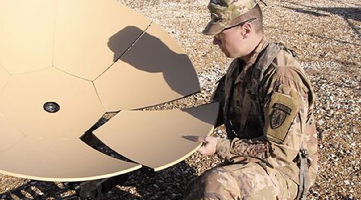 A US Army soldier assembles an expeditionary ground terminal for satcom operations.