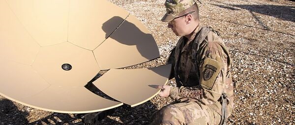 A US Army soldier assembles an expeditionary ground terminal for satcom operations.