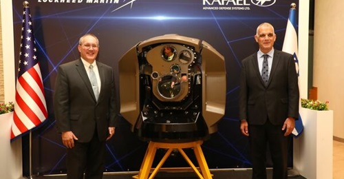 Frank St John, chief operating officer of Lockheed Martin, and Major General (retd) Yoav Har-Even, Rafael CEO and president, standing on either side of the laser director from the Iron Beam system unveiled earlier by the Israeli company.