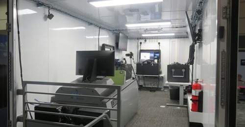 Mobile DJFT. The MVRsimulation trailer-mounted DJFT displayed at I/ITSEC 22. Front left: PTMT; rear, l-r: role player station, observer station, instructor operator station.