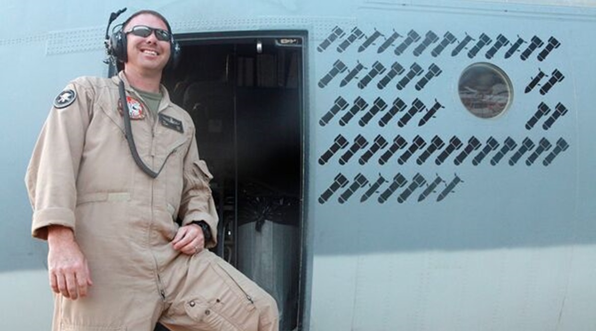 An airman poses next to the operational 'kill' markings stencilled onto the fuselage of a Harvest HAWK in Afganistan during the war fighting stage of the conflict, giving an indication of the type's work rate in the close air support role. The USMC has...