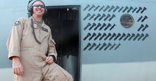 An airman poses next to the operational 'kill' markings stencilled onto the fuselage of a Harvest HAWK in Afganistan during the war fighting stage of the conflict, giving an indication of the type's work rate in the close air support role. The USMC has...