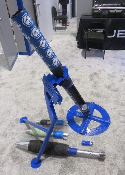 A demonstration version of Cubic's 81 mm mortar training solution shown at 2022 Interservice/Industry Training, Simulation, and Education Conference (I/ITSEC 22). The three bombs beside it are 60 mm, 81 mm, and 120 mm training rounds. The small blue ob...