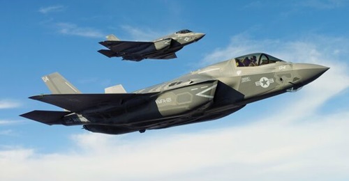An F-35B short take-off and vertical landing variant and F-35C carrier variant aircraft fly together over Fort Worth, Texas, on functional check flights on 14 March 2013.