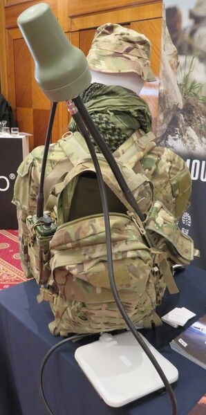 The Hughes 9203 BGAN Patrol manpack satcom system shown at the SAE Media Mobile Deployable Communications 2023 conference, London. The white square object is the BGAN modem, which is carried in the backpack.