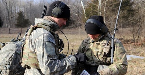 A forward observer with C Company, 1-508th Parachute Infantry Regiment, 82nd Airborne Division (Air Assault) uses AN/PRC 148 2-channel Leader Radio to transmit position location obtained from the Android Tactical Assault Kit during a live-fire exercise...