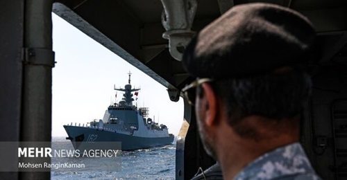 An Iranian sailor looks at the Chinese destroyer 
        
         during an exercise in March that also involved the Russian frigate 
        
        . 
        
        also visited Abu Dhabi during the IDEX defence show in February.
