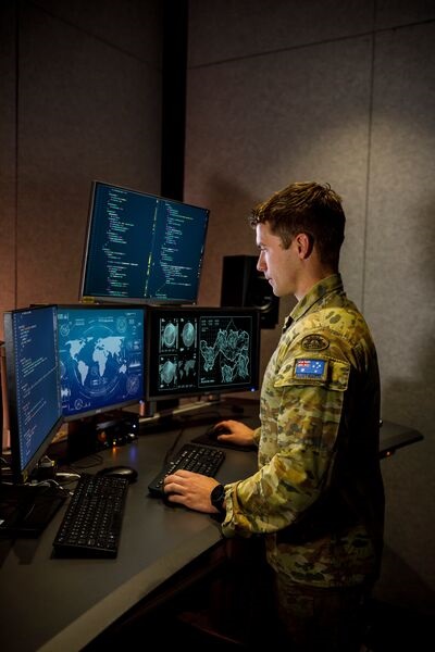 An Australian Army cyber warfare specialist at workstation. Australia's new DSR emphasises the need to develop a comprehensive framework for managing cyber domain operations, strengthening cyber-defence capabilities, and building a cyber-defence workfo...
