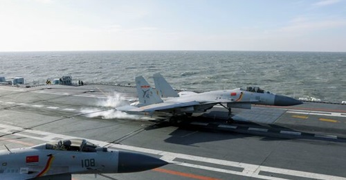 A file image of J-15 operations on the deck of 
        
        . The carrier's sister ship, 
        
        , carried out a series of operations in the Western Pacific, including a passage near Guam, in April 2023.