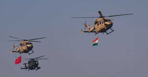 Two Indian Army HAL Dhruv helicopters fly in formation with a Dhruv Mk IV (Rudra) armed helicopter during a parade on 9 January 2023. The Indian Army operates 144 Dhruvs.