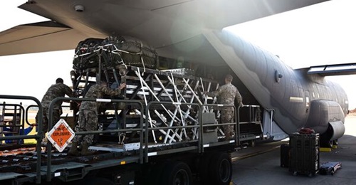 Airmen and riggers with the 1st Special Operations Squadron Logistics Readiness Squadron load a Rapid Dragon Palletized Weapon System aboard an MC-130J Commando II in December 2021.