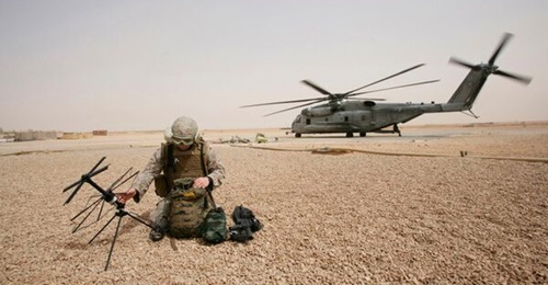 A US Marine Corps field radio operator from the 26th Marine Expeditionary Unit sets up satellite communication at Camp Korean Village, Iraq, in 2008.