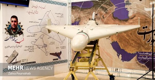 The Shahed-136 displayed at the IRGC exhibition in Qom with the information poster behind it.