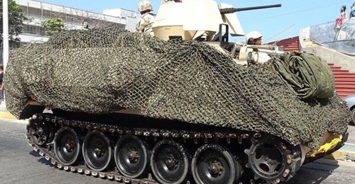 M-113A2 Colombian, with desert scheme and camouflage mesh.
