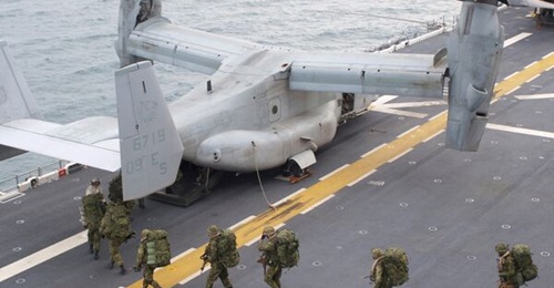 US marines filing into an MV-22 on 
        
         off the coast of North Carolina during Exercise 'Bold Alligator' in 2012.