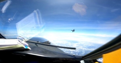 A Chinese SAC J-16 fighter flies in front of a USAF RC-135V Rivet Joint aircraft over the South China Sea on 26 May 2023. This is a screen-grab from a video of the incident.