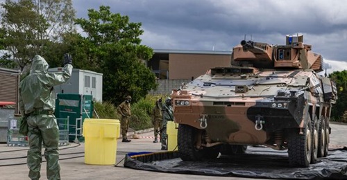 The Australian Army sappers guide a Boxer CRV through the decontamination bay during the CBRN defence training at Gallipoli Barracks, Brisbane.
