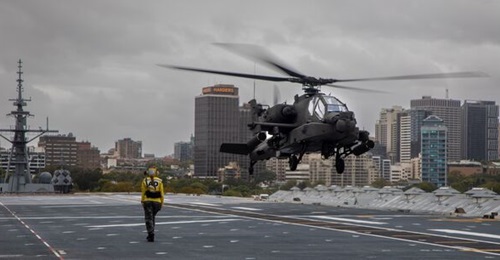Australia will likely use the AH-64E Apaches with its Canberra-class Landing Helicopter Docks. In this photo, a US Army AH-64E lands on HMAS 
        
         during a training activity at Sydney in February 2023.
