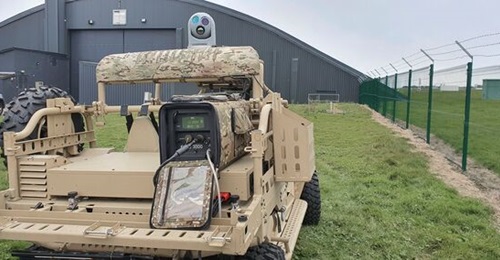 The ZeroAlpha Solutions ZAS-PM-093 Auxiliary Power Module mounted in the load bed of a Polaris M-RZR D. On top of it is the SFC Energy EMILY 3000 methanol fuel cell. Note the electro-optic/infrared turret for which the APM provides power.