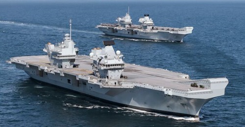 The RN's second-in-class aircraft carrier HMS 
        
        s (foreground), pictured sailing with sister ship 
        
         for the first time in the North Atlantic in May 2021.