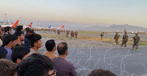 Afghan crowds gather at the airport as US soldiers stand guard in Kabul on August 16, 2021.