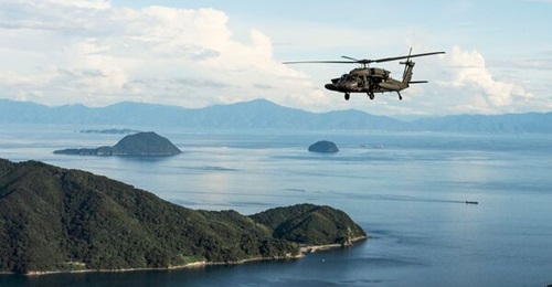 A US Army UH-60 Black Hawk flies in formation over Yamaguchi Bay during joint exercises with the US and Japan during 'Orient Shield'.
