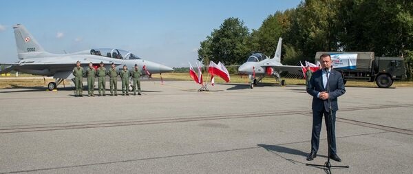 Polish Minister of National Defence Mariusz Blaszczak speaking in front of the first two FA-50 combat aircraft to be delivered to the Polish Air Force.