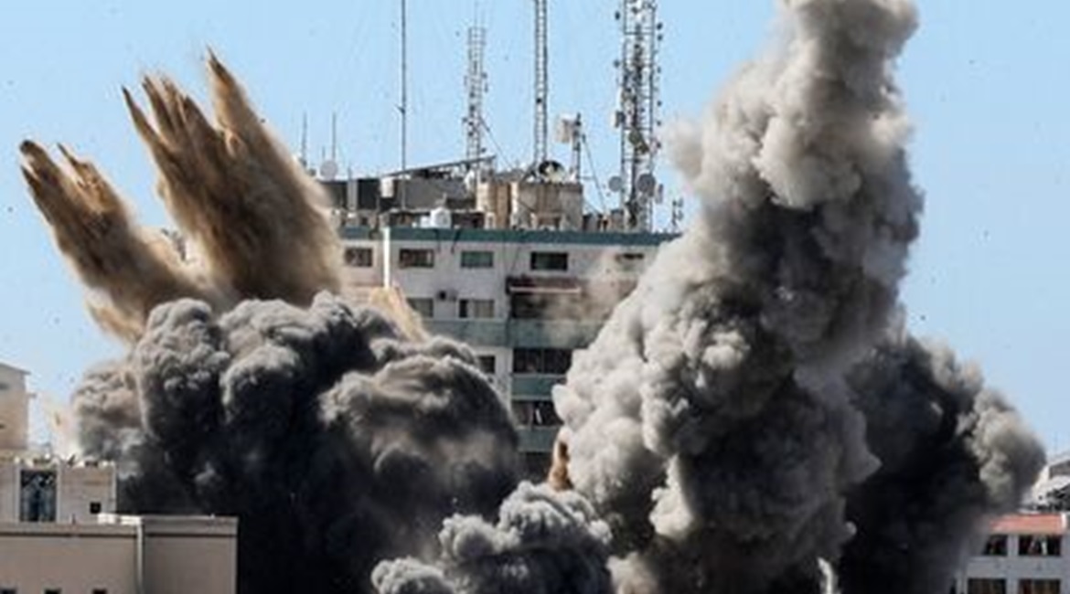 A munition hits the Al-Jalaa Tower in the Gaza Strip as a second guided bomb descends towards the building on 15 May.