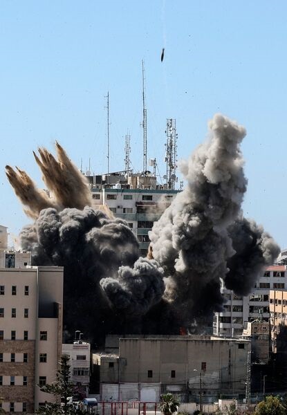 A munition hits the Al-Jalaa Tower in the Gaza Strip as a second guided bomb descends towards the building on 15 May.