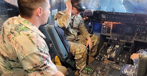 Boeing Australia FSR Luc de Leacy (left) and USAF Airman First Class Anthony Cardoni on the flight deck of a USAF C-17 Globemaster III transport aircraft during a field test of Boeing's ATOM technology.