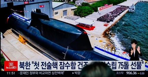 A TV screen at a railway station in Seoul shows an image of the launch of North Korea's new 'tactical nuclear attack submarine'.