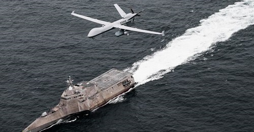 An MQ-9 Sea Guardian unmanned maritime surveillance aircraft system flies over Independence-variant littoral combat ship USS Coronado (LCS-4), during the US Pacific Fleet's 'Unmanned Systems Integrated Battle Problem (UxS IBP) 21'.