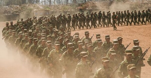 In this photo taken in March 2023 members of ethnic rebel group Ta'ang National Liberation Army (TNLA) take part in a training exercise at their base camp in the forest in Myanmar's northern Shan State.