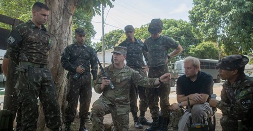 US Army Major Aaron Spence, an international technology integrator assigned to Army South, demonstrates the RIC-U to a group of Brazilian soldiers. US Army National Guard photo by Staff Sergeant Jonathan Pietrantoni.