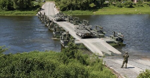 A number of M3 units forming a pontoon bridge. The four units gifted to Latvia will enhance NATO's wet-gap crossing capabilities in the Baltics.