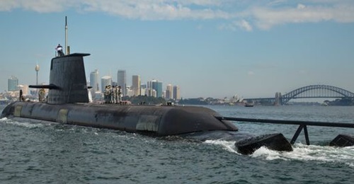 HMAS 
        
         sails through Sydney Harbour as the boat prepares to berth at Fleet Base East, Sydney. Commissioned in July 1999, HMAS 
        
         is the third of six RAN Collins-class submarines.