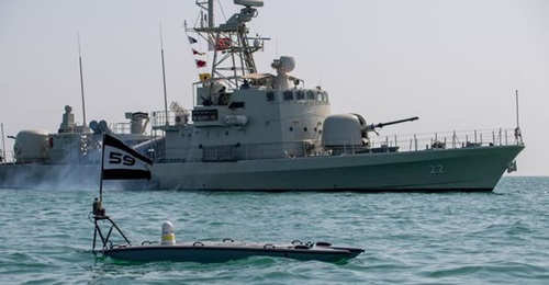 A MANTAS T-12 USV, front, operates alongside Royal Bahrain Naval Force fast-attack craft RBNS 
        
         during operations in support of Task Force 59 in the Gulf.