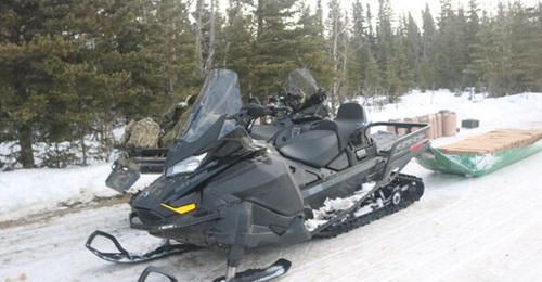 A US Army snow machine pulls a sled full of Meals, Ready-to-Eat during the Joint Pacific Multinational Readiness Center 24-02 training rotation in February 2024.