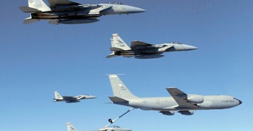 A USAF Boeing KC-135R refuels a flight of F-15C Eagles.