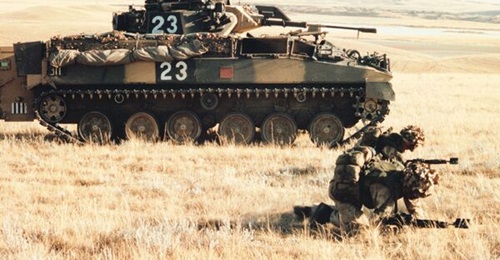Saab has been contracted to upgrade the army's live training capability. Pictured are troops practising their debussing drills from a Saab DFWES-equipped Warrior infantry combat vehicle in Alberta.