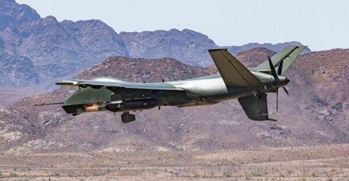 A GA-ASI Mojave UAV performs a gun-run with a Dillon DAP-6 podded minigun.