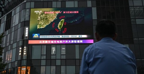 An outdoor screen shows a news coverage of China's military drills around Taiwan, Beijing, on 23 May 2024. On 23 May China launched 'Joint Sword-2024A' exercises, surrounding Taiwan with warplanes and navy ships and vowing 'stern punishment' to separat...