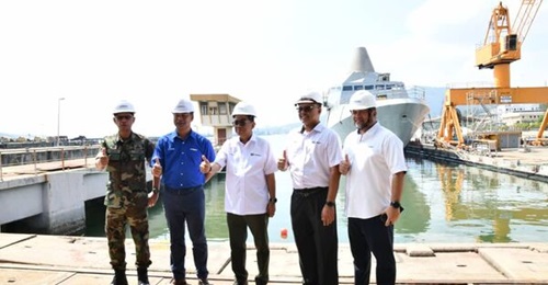 Malaysian Minister of Defence Mohamed Khaled Nordin at the Lumut Naval Base on 4 June 2024, where it was disclosed that the country's first LCS (seen here in the background) was launched into the water on 23 May 2024.