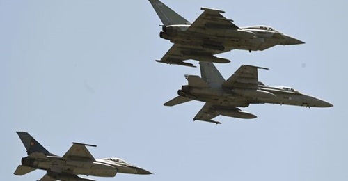 A Finnish Air Force Hornet is flanked by an RAF Typhoon and a Romanian Air Force F-16 as the Nordic country takes on its first NATO air policing mission since joining the alliance.