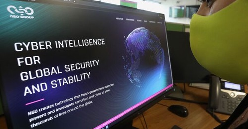 A woman consults the website of the Israeli NSO Group, makers of Pegasus spyware, in Nicosia, Cyprus, on 21 July 2021. NSO Group has denied media reports that its Pegasus software is linked to the mass surveillance of journalists and human rights defen...